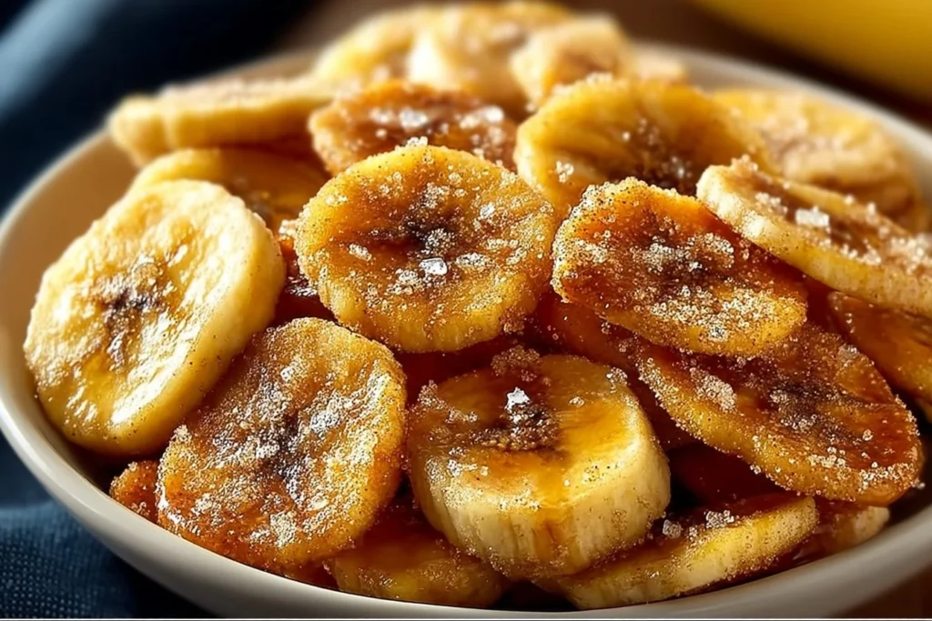 Cinnamon-sugar air fryer banana chips in a bowl, a healthy snack option.